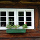 Wiejskie okienka z pelargoniami.
