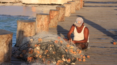 rybak naprawiający sieci w Puerto Morelos – Meksyk